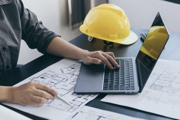 Stock Engineering Photo with Hardhat and Plans